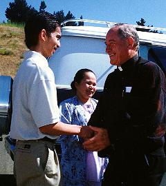 Julius shakes Fr. Kinane's hand